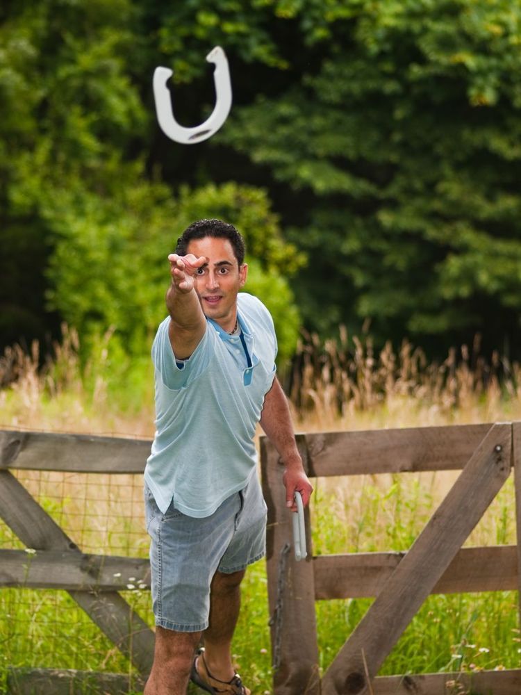 Someone throwing a horseshoe.