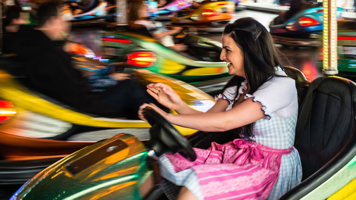 People driving fast moving bumper cars. 