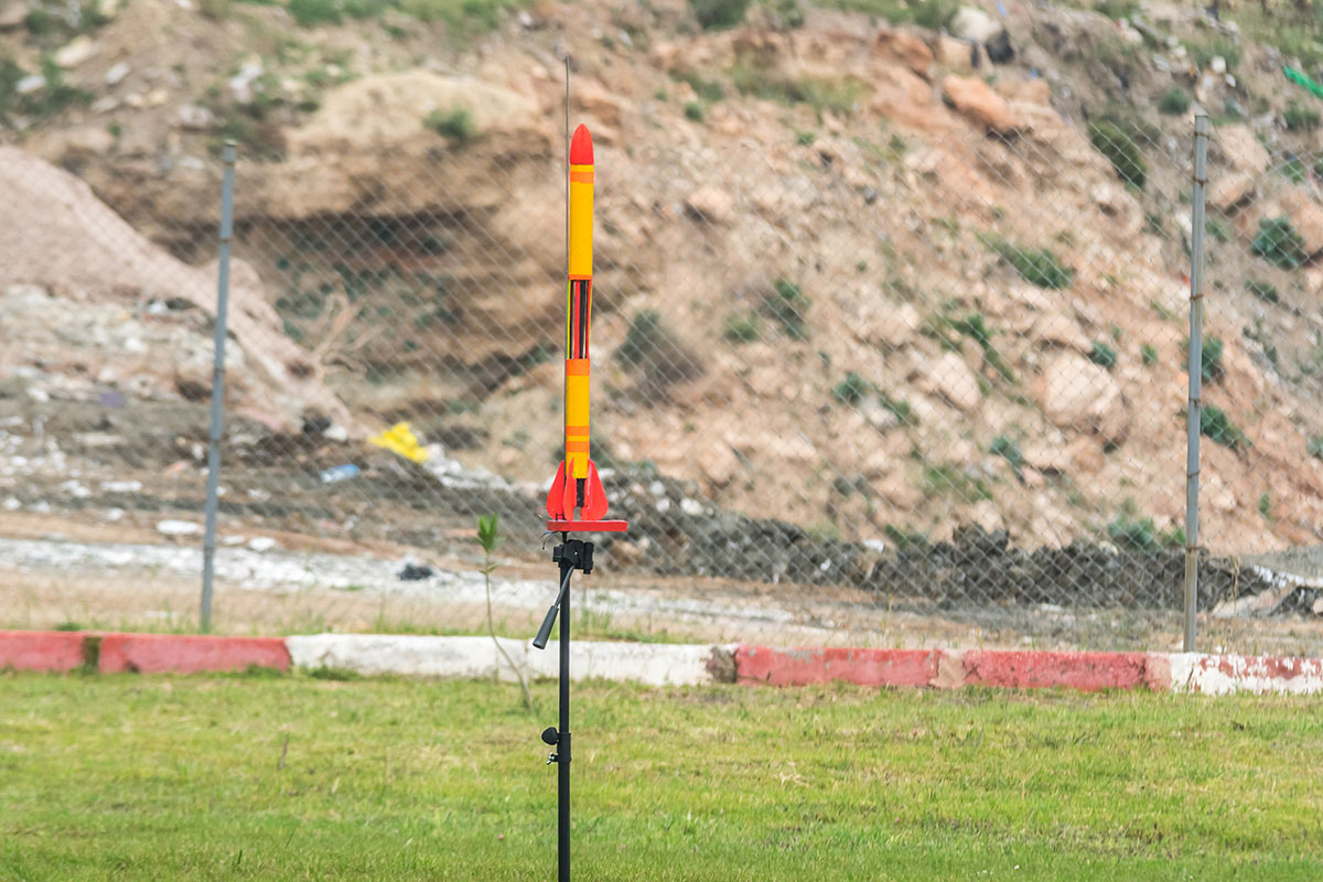 model rocket launching vertically from a platform
