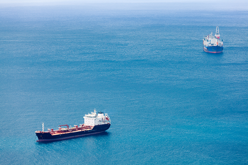 two cargo ships travelling across an ocean