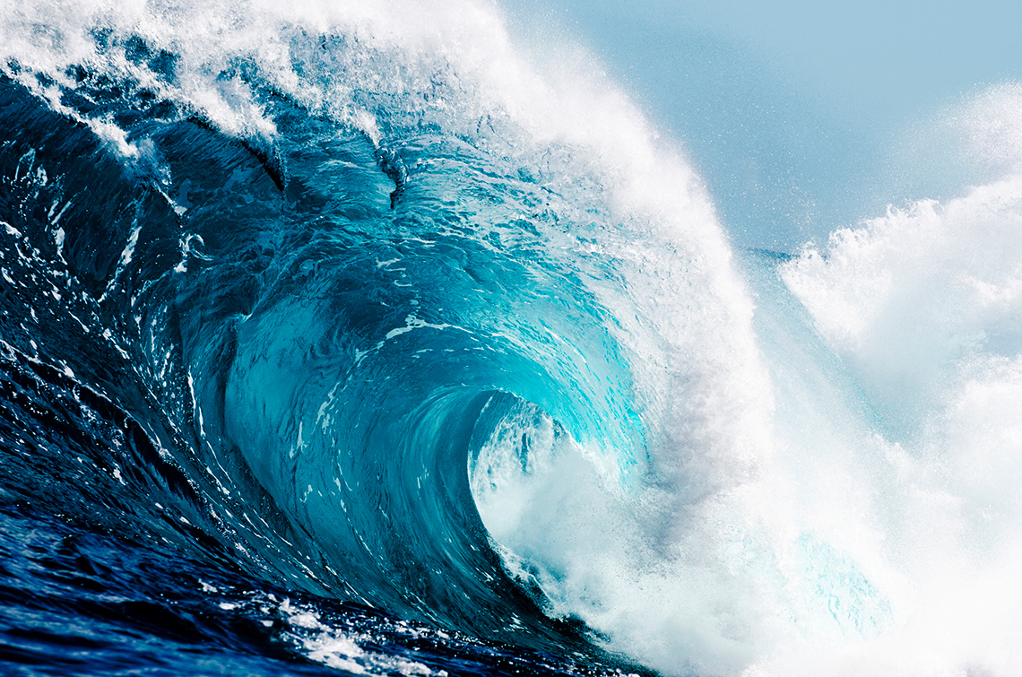 Ocean waves curling and crashing to shore.